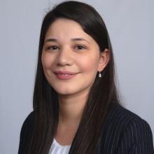 Jahanett Ramirez with dark long hair and a dark blazer