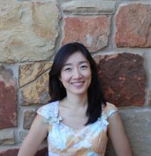 Mina Kim Headshot with short dark hair and white blouse