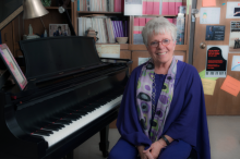 Martha Hilley seated at her piano