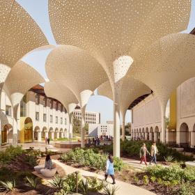 Image of the Blanton Museum lawn with several people walking through the paths